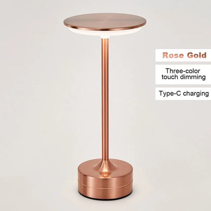 Rose gold LED table lamp with text indicating features on a light gray background