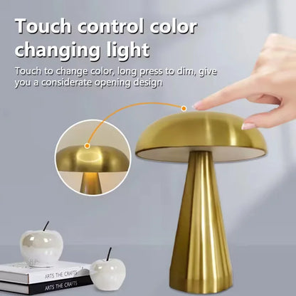 Gold table lamp with touch control feature on a gray background